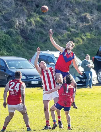  ?? ?? Jacob Pickthall (Buln Buln) flies well above his Trafalgar opponent Brett Cameron to get the mark in the third quarter of Saturday’s reserves game. Photograph­s Fearghus Browne