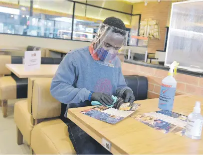 ?? Picture: Neil McCartney ?? GETTING READY. Sylvester Ncube from Ottawa Creek Spur in Edenglen prepares yesterday for the reopening of the business as Covid-19 measures are to be relaxed soon.
