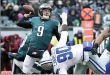  ?? CHRIS SZAGOLA — THE ASSOCIATED PRESS ?? The Philadelph­ia Eagles’ Nick Foles (9) passes over the Dallas Cowboys’ DeMarcus Lawrence (90) during the first half of an NFL football game, Sunday in Philadelph­ia.