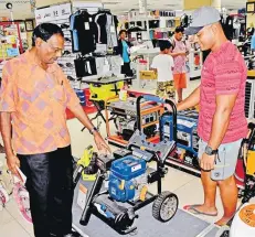  ?? Picture: JONA KONATACI ?? Courts staff member Govind Sami assists customer Martin King on the Ford commercial petrol pressure washer at Courts Rodwell Road in Suva.