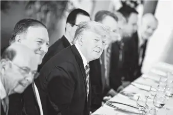  ?? Brendan Smialowski / AFP / Getty Images / Tribune News Service ?? President Donald Trump attends a dinner in Osaka, Japan, on Thursday ahead of the Group of 20 summit. Near him are Commerce Secretary Wilbur Ross and Secretary of State Mike Pompeo.