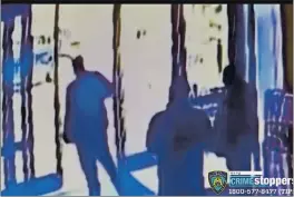  ?? COURTESY OF NEW YORK POLICE DEPARTMENT ?? This image taken from surveillan­ce video shows an apartment building employee, center, closing the building’s front door after a man assaulted a 65-year-old Asian American woman a few blocks from New York’s Times Square.