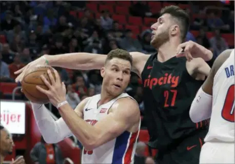  ?? CARLOS OSORIO — THE ASSOCIATED PRESS ?? Portland center Jusuf Nurkic (27) reaches in on Pistons forward Blake Griffin (23) Monday in Detroit.