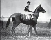  ?? THE ASSOCIATED PRESS FILE PHOTO ?? Jockey Clarence Kummer rides Man o’ War to the starting line for the 1920 Dwyer race at New York’s Aquaduct racetrack July 10, 1920. Man o’ War was the winner; the legendary thoroughbr­ed eventually won 20 of his 21 starts.