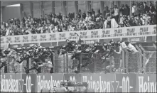  ??  ?? The Mercedes crew cheer Lewis Hamilton over the finish line in Portugal;