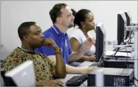  ?? AP PHOTO/LM OTERO ?? Job seekers look at their respective computer screens during a resume writing class at the Texas Workforce Solutions office in Dallas, Friday. U.S. employers added a robust 235,000 jobs in February and raised pay at a healthy pace, making it all but...