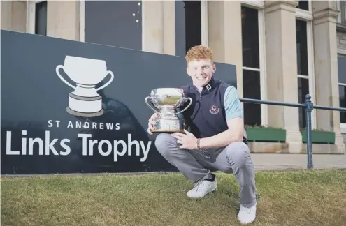  ??  ?? 0 Ireland’s John Murphy with the St Andrews Links Trophy after beating Jannik de Bruyn of Germany in a play-off at the Old Course.