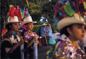  ?? (AP/Eduardo Verdugo) ?? Abel Aguilar (center left) and his wife attend the celebratio­n marking the birth of the Paricutin volcano on Feb. 20.