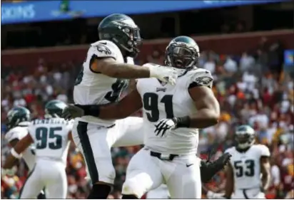  ?? ALEX BRANDON — THE ASSOCIATED PRESS ?? Eagles defensive tackle Fletcher Cox, right, celebrates with Derek Barnett confirmed his touchdown on a fumble return in the fourth quarter. after officials reviewed and