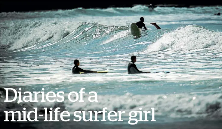  ?? MAIN PHOTO: ROBERT KITCHIN/STUFF ?? Happiness is not a state that’s easy to get to but Michelle Duff, below left, says her new-found passion for surfing and her beginner’s board, below right, at Lyall Bay, above, gets her there every time.