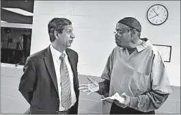  ??  ?? Anil Makhija, dean of the Fisher School of Business at Ohio State, left, talks with Marquette Boone about his business plan.