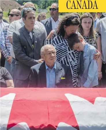  ?? TYLER ANDERSON / NATIONAL POST ?? Family gather around the flag-draped casket of Nazzareno Tassone during the funeral for the young Niagara Falls resident, who was killed in December while fighting with Kurdish forces against ISIL in Syria.