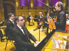  ??  ?? Piano soloist Saleem Ashkar and VSO music director Otto Tausk prepare Monday before the start of the performanc­e of Beethoven’s Piano Concerto No. 4 in an empty Orpheum.