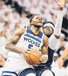  ?? — AFP photo ?? Anthony Edwards of the Minnesota Timberwolv­es drives to the basket while defended by Reggie Jackson of the Denver Nuggets.