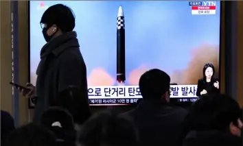  ?? Jung Yeon-Je/AFP via Getty Images ?? People watch a television screen showing a news broadcast with file footage of a North Korean missile test Friday at a railway station in Seoul, South Korea.