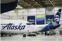  ?? LINDSEY WASSON / AP ?? Alaska Airlines aircraft sit in the airline’s hangar at Seattle-Tacoma Internatio­nal Airport on Jan. 10 in SeaTac, Wash. Boeing has acknowledg­ed in a letter to Congress that it cannot find records for work done on a door panel that blew out on an Alaska Airlines flight over Oregon two months ago.