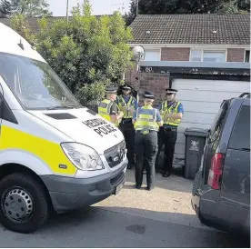  ??  ?? Police officers stand outside a property in, Pentwyn, Cardiff, believed to be the home of Darren Osborne, pictured left