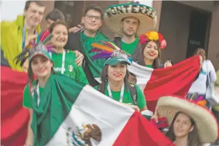  ??  ?? Mexican soccer fans pose for a photo on the eve of the opener of the 2018 soccer World Cup on Wednesday near Red Square in Moscow.