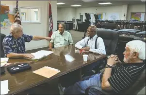  ?? The Sentinel-Record/Grace Brown ?? FIRE DISTRICT ELECTIONS: Garland County Election Commission Chairman Gene Haley, left, speaks Monday with commission­ers Ralph Edds and Elmer Beard and voting technician Butch Davis before early voting begins today for July 9 fire district elections held by the 70 West and Piney fire department­s.