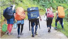  ??  ?? Lead pack of PLDT and Smart volunteers carrying Smart’s School-in-a-Bag on the final leg of their climb to Sitio La- nipew in the remote municipali­ty of Kibungan