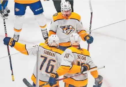  ?? THE ASSOCIATED PRESS ?? Nashville Predators left wing Austin Watson, top, celebrates his goal against the Colorado Avalanche with P.K. Subban (76) and Colton Sissons during the first period of Sunday’s game in Denver. The Predators won 5-0 to wrap up the Western Conference...