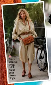  ?? ?? Sue Giers wears a beige midi dress with brown clogs