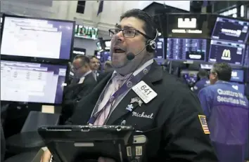  ?? Richard Drew/Associated Press ?? Trader Michael Capolino works on the floor of the New York Stock Exchange on Tuesday. Energy and industrial companies are leading stocks higher in early trading on Wall Street.