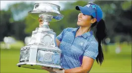  ?? Charles Rex Arbogast ?? The Associated Press Las Vegas resident Danielle Kang holds the trophy Sunday after winning the KPMG Women’s PGA Championsh­ip at Olympia Fields Country Club.