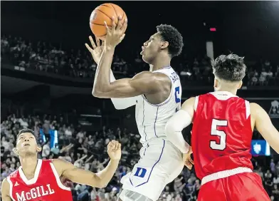  ?? DAVE SIDAWAY / POSTMEDIA NEWS ?? Duke’s R.J. Barrett takes a shot during exhibition action against the Mcgill Redmen at Place Bell in Laval. A slick marketing campaign and star power attracted a sell-out crowd of 10,098.