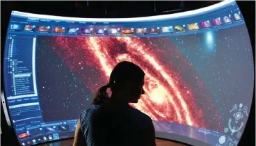  ?? Picture: THOMAS JARRETT ?? LOST IN SPACE: Dr Maria Kapala admiring an immersive view of the Andromeda Galaxy.