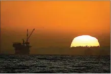  ?? CHRIS CARLSON / AP / FILE ?? Offshore oil drilling platforms are seen at sunset near Huntington Beach in 2020. California’s uneasy relationsh­ip with the oil industry is being tested again by the latest spill to foul beaches and kill birds and fish off Orange County.