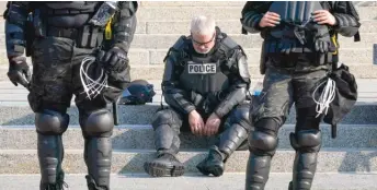  ?? MORRY GASH/AP ?? Police in riot gear outside the Kenosha County Courthouse on Monday.