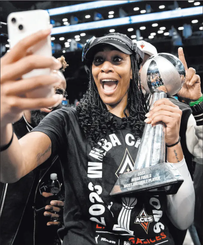  ?? Ellen Schmidt Las Vegas Review-journal @ellenschmi­dttt ?? Incomparab­le Aces forward A’ja Wilson poses for a selfie with her MVP trophy after she and her team captured their second consecutiv­e WNBA championsh­ip.