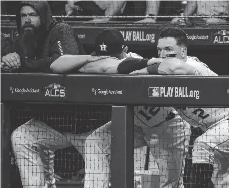  ?? Brett Coomer / Staff photograph­er ?? Tbird baseman Alex Bregman, right, watches glumly from the dugout as the Astros fail to mount a rally in the ninth inning.