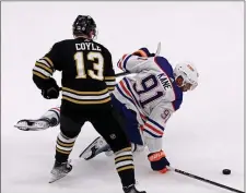  ?? (STAFF PHOTO — STUART CAHILL/BOSTON HERALD ?? Boston Bruins center Charlie Coyle (13) takes out Edmonton Oilers left wing Evander Kane during Tuesday’s NHL clash at the TD Garden.