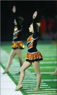  ?? DAVID TURBEN — THE NEWS-HERALD FILE ?? North High School cheerleade­rs perform a routine during a football game.