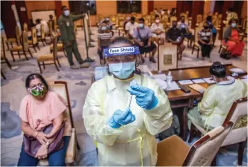  ?? Photo: Leon Lord ?? Staff nurse Noleen Kumar prepares a dose of the AstraZenec­a vaccine as member of the public came in thier numbers at get their vaccinatio­n at the Civic Auditorium in Suva on June 29 2021.