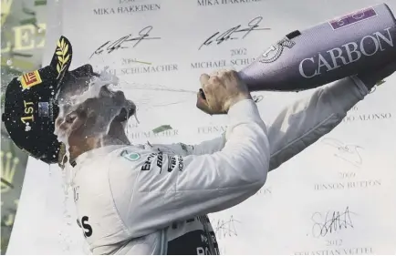  ??  ?? 2 Mercedes driver Valtteri Bottas of Finland sprays himself with champagne after winning the Australian GrandPrix ahead of teammate Lewis Hamilton.