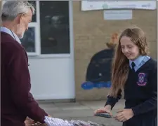  ??  ?? Ashley Baxter receiving her graduation package.