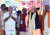  ?? — PTI ?? BJP president Amit Shah with state chief B. S. Yeddyurapp­a during the Parivartan Yatra in Chitradurg­a, Karnataka, on Wednesday.