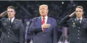  ?? AFP ?? Did he forget? President Donald Trump stood up in an Atlanta sports stadium when the US national anthem was played. On social media, supporters praised him for standing with his hand over his heart, but critics said it looked as if he had forgotten the...