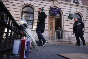  ?? (AP/Yuki Iwamura) ?? A makeshift memorial is seen outside the New York Police Department 32nd Precinct near the scene of shooting in Harlem on Saturday in New York.