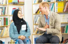  ?? FADI AROURI/POOL PHOTO VIA AP ?? Britain’s Prince William visits with a Palestinia­n student Wednesday inside a school in the Jalazoun refugee camp near the West Bank city of Ramallah.