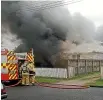  ?? CHEY WHARERIMU ?? Smoke billows from a Levin home engulfed in flames.