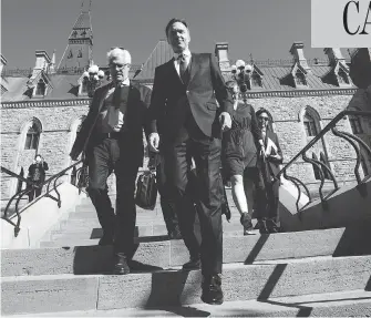  ?? SEAN KILPATRICK / THE CANADIAN PRESS ?? Natural Resources Minister James Carr and Finance Minister Bill Morneau leave a cabinet meeting on Parliament Hill Tuesday, after announcing that Canada is going to buy the Trans Mountain pipeline.