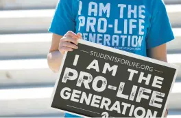  ?? ALEX WONG/GETTY ?? Just five days after Roe v. Wade was overturned, a anti-abortion activist holds a sign during a demonstrat­ion on June 29 in front of the U.S. Supreme Court.