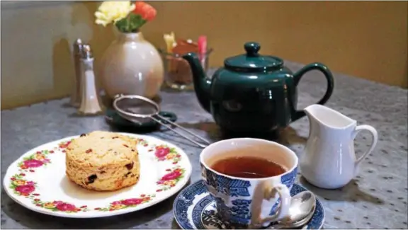  ?? PHOTO BY EMILY RYAN ?? Enjoy a cup of tea with a cranberry and orange scone, January’s “scone of the month” at A Taste of Britain in Wayne.