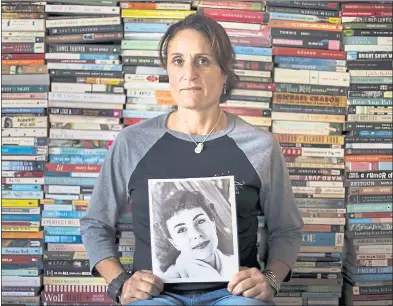  ?? PHOTOS BY LIPO CHING — STAFF PHOTOGRAPH­ER ?? Juliana Furtado, at her home in Ben Lomond, holds a photo of her mother, Nina Armagh, who blamed her children for her suicidal thoughts and committed suicide in 1995. Furtado says reading helped her cope with her childhood issues.