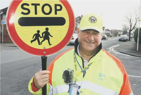  ??  ?? Worthing lollipop man Terry Rickards with his body-worn camera