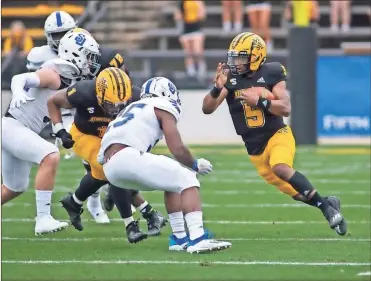  ?? Marietta Daily Journal - Anthony Stalcup ?? Kennesaw State quarterbac­k Tommy Bryant runs the ball during the Owls’ season-opening win over Shorter.